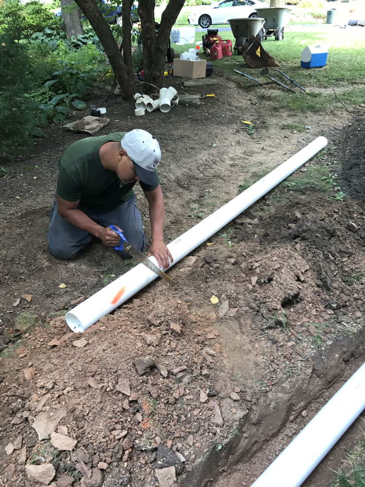 Putting a drainage pipe in the ground